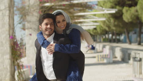 Happy-muslim-couple-having-fun-at-seashore-on-sunny-day.