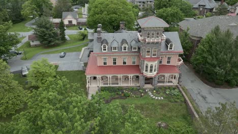 aerial drone view of large red mansion