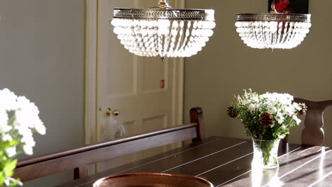 Large-kitchen-banquet-table-with-crystal-pendant-lights