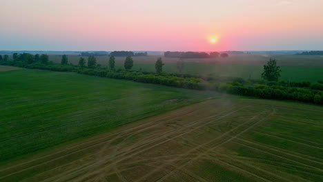Sunrise-over-foggy-fields-in-Europe,-aerial-drone-view