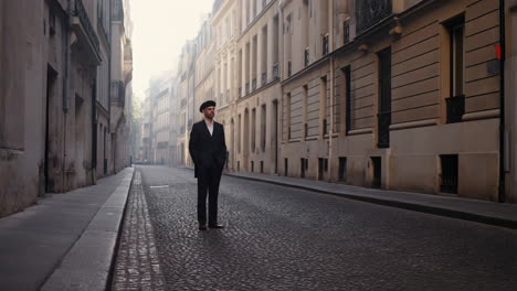 man in beret on a cobblestone street
