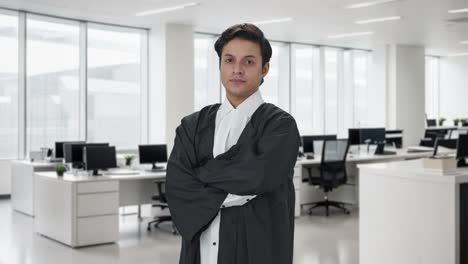 portrait of confident indian lawyer standing crossed hands