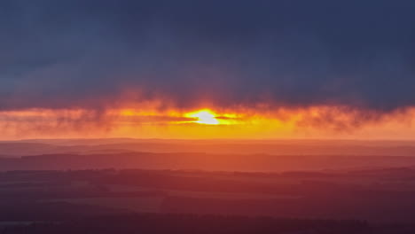 through an aerial lens, fields glow in amber and lavender hues as the sun bids