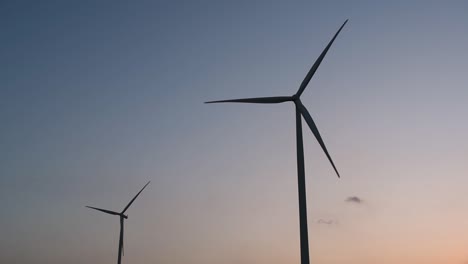 Wind-Turbines-Silhouette-against-the-Blue-sky-during-Sunset,-clean-alternative-energy-in-Thailand-and-mainland-Southeast-Asia