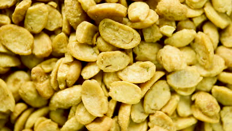 close up of dry toasted soybeans halves rotating