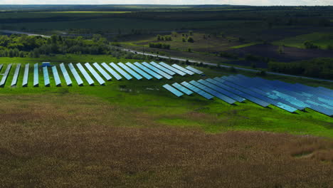 Aerial-view-blue-solar-panels-park.-Solar-batteries-farm-in-green-field.