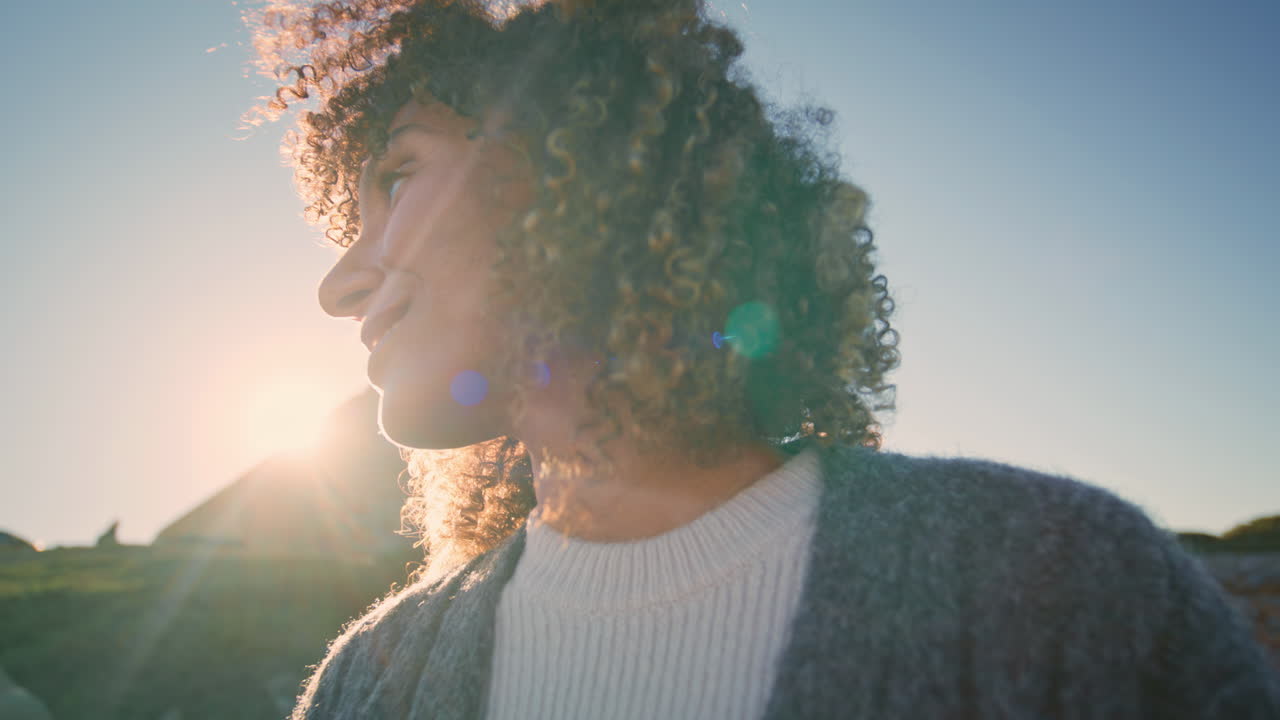 Carefree brunette resting sunset nature alone closeup. Curly hair model relaxing