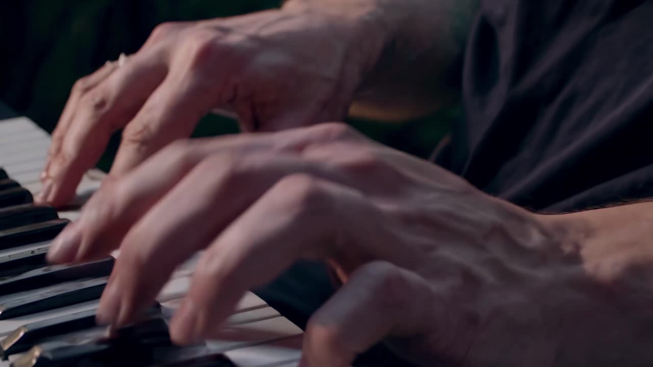 Close-up video of hands playing piano keys, capturing intricate finger movements