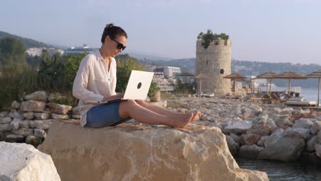 typing work on sea shore.