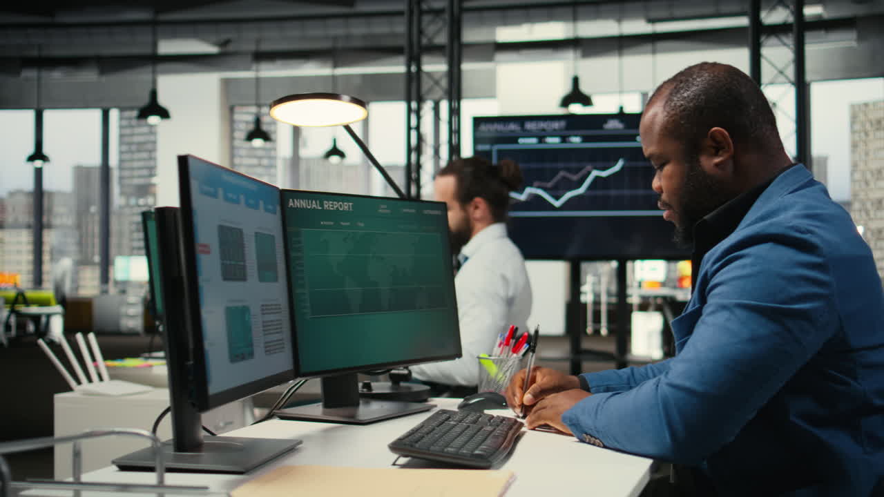 Vertical Video African american analyst writing growth strategy notes on a textbook