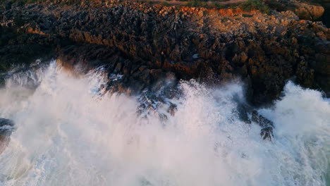 coast washed foamy ocean water drone view. sea waves crashing of coastal stones