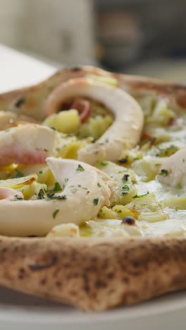 gourmet pizza with octopus and potatoes is ready to be served at the resort