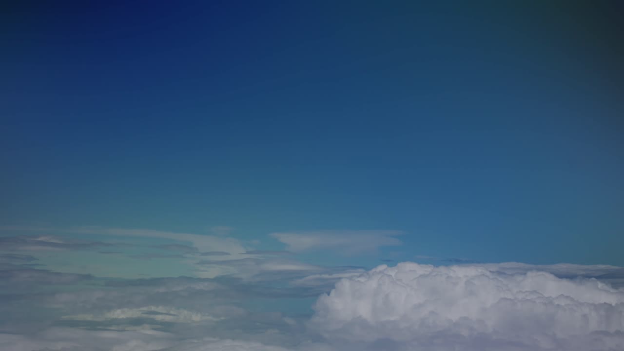View of clouds slowly passing by from a chromatic airplane window, Stuttgart, Europe