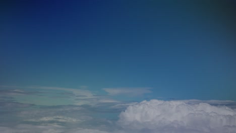 View of clouds slowly passing by from a chromatic airplane window, Stuttgart, Europe