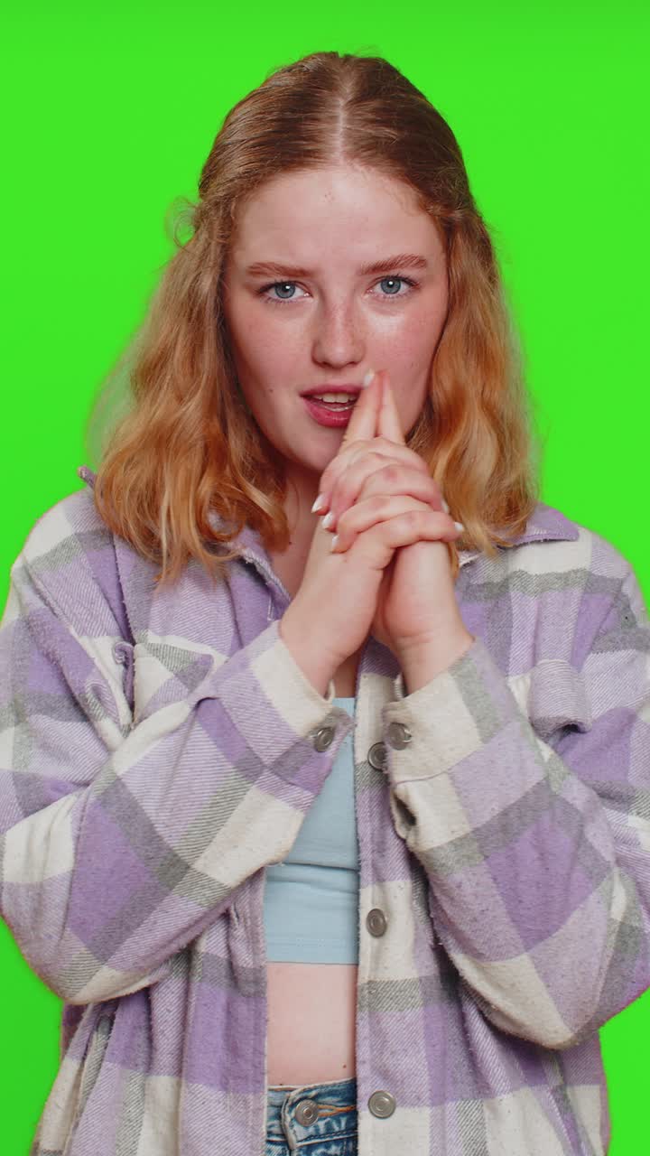 Young woman pointing around with finger gun gesture making choice shooting killing with hand pistol