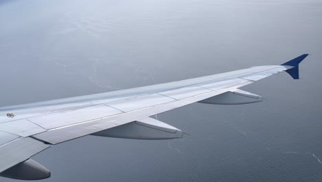 airbus a320 airplane wing in flight, passenger window view