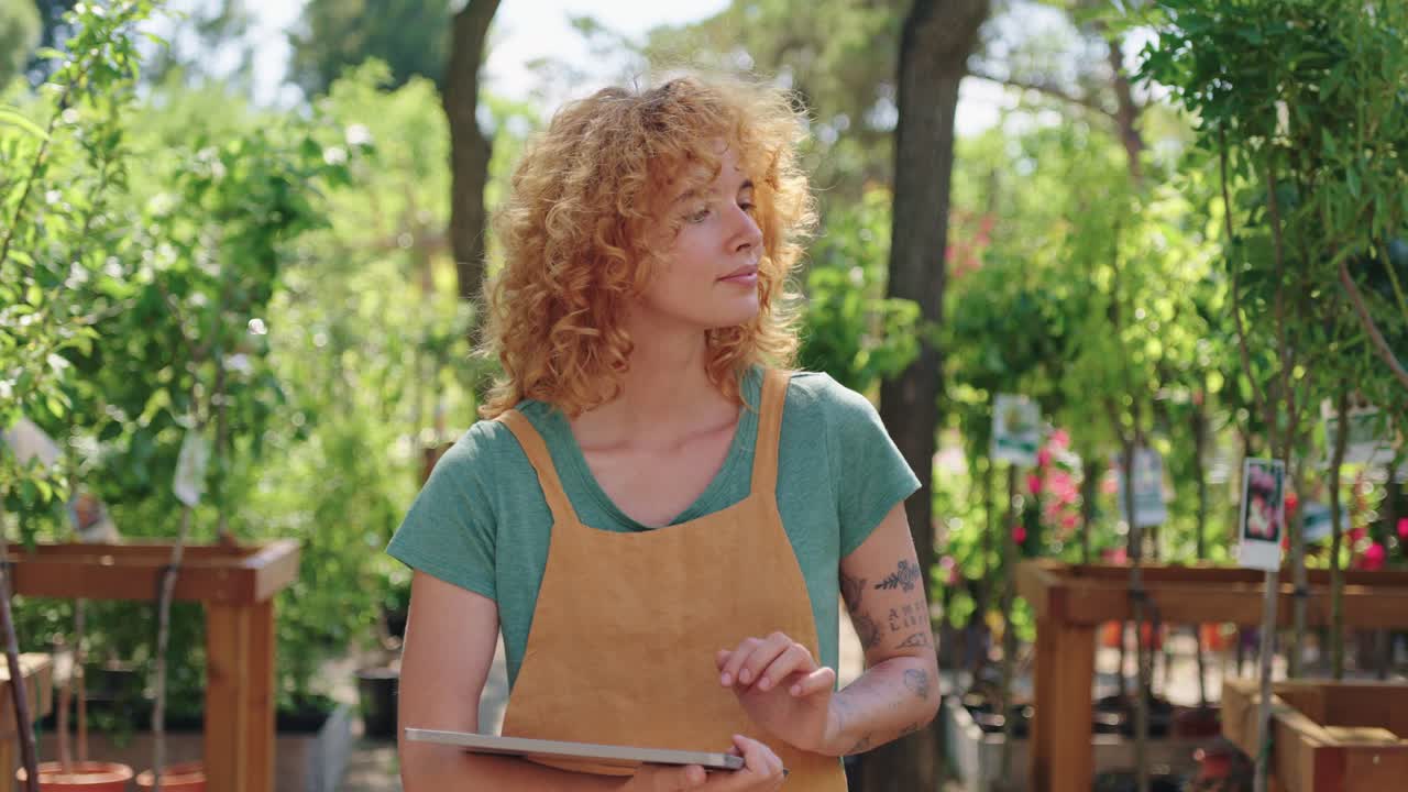Woman using a digital tablet in a garden center