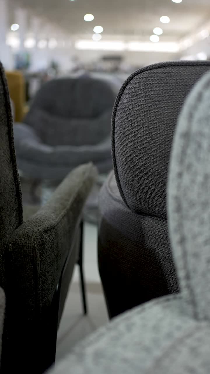 This display highlights a close-up of a modern chair in a furniture store. The unique fabric texture and design elements showcase quality craftsmanship and style