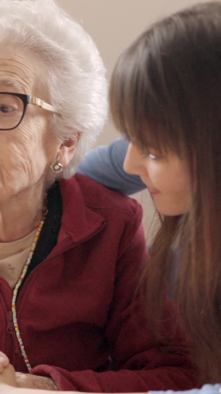 Granddaughter cheers up her sad grandmother in a nursing home