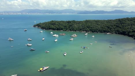 tropical protected beach with charter boats in caixa d'aco in porto belo, santa catarina, brazil. aerial drone shot