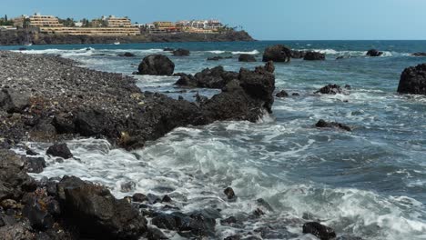 volcanic black rock beach in las galletas, tenerife, canary islands