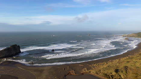 Sixes-River-meets-Pacific-Ocean,-Blacklock-Point-in-background