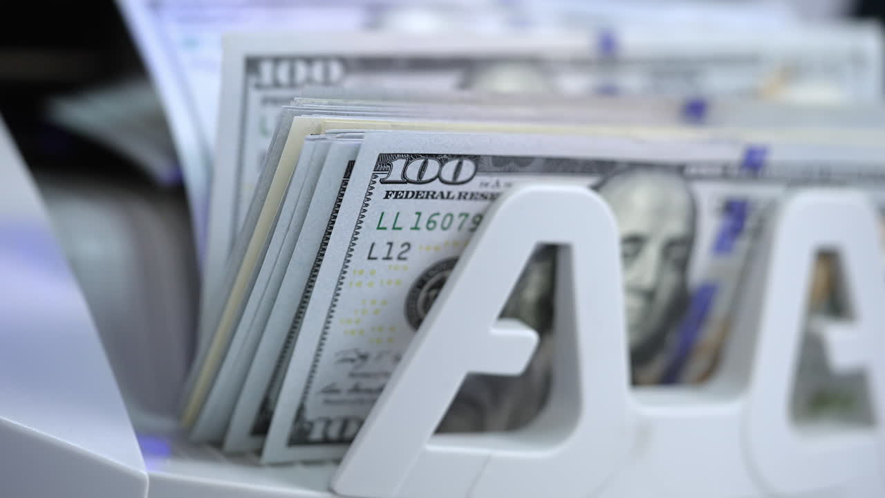 Money counting equipment for paper money calculation. Automatic mechanism for bank financial operations. Currency exchange of one hundred usd. Closeup currency counting machine counting dollar bills