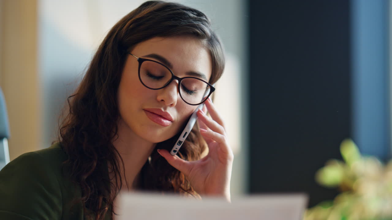 Tired office manager calling telephone at office close up. Sad girl consultant