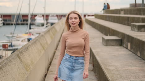 Young-woman-confidently-walking-near-the-harbor.