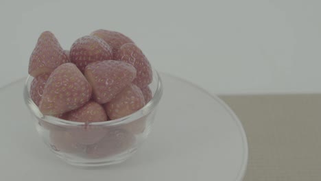 fresh, ripe, red strawberries in rotating bowl, ungraded