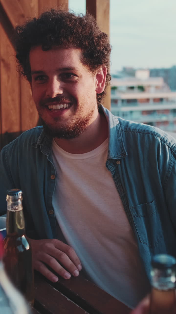 Man enjoying beer on balcony