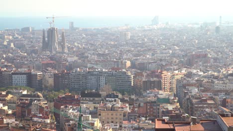 handheld static looking down at the city of barcelona with la sagrada familia in the background