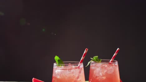 close up of drinks with watermelons on wooden table, with copy space