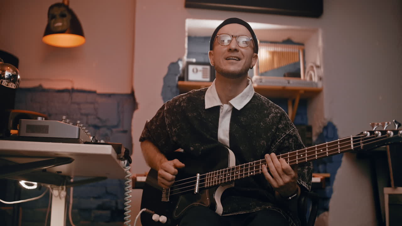 Musician Playing Bass Guitar in a Recording Studio