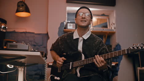 musician playing bass guitar in a recording studio