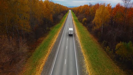 Autumn Road Through the Forest with Truck