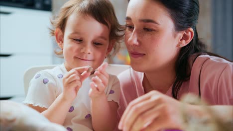 a heartwarming moment: mother and child bonding over colorful crafting activities, sharing laughter and creativity in a joyful learning environment at home