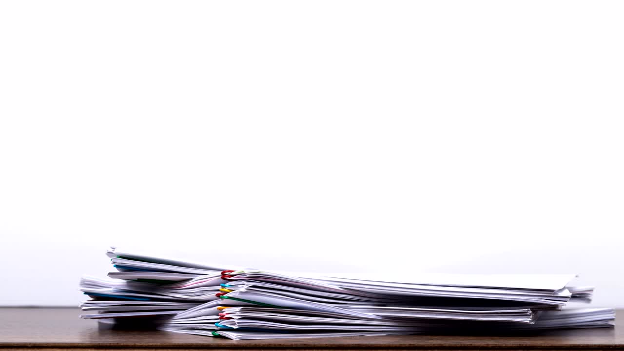 Stack overload document report paper with colorful paperclip on white background, business concept footage paperless used – 4K Stop motion.