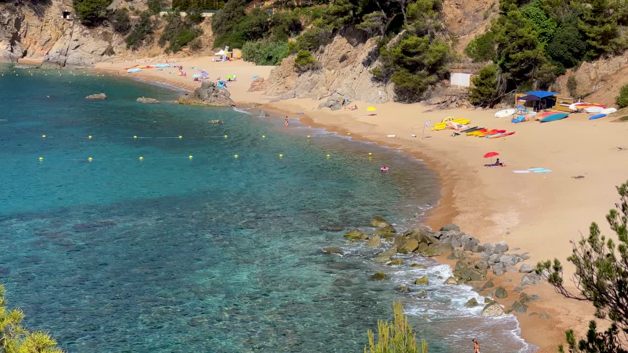 Costa Brava beautiful virgin transparent turquoise waters lush vegetation of pine trees and rocks yellow sand few people Gerona Catalonia Mediterranean Panoramic views Tossa de Mar cove Llevad?