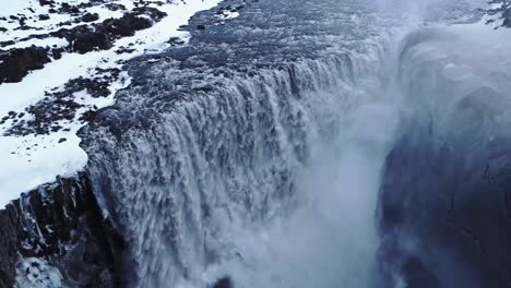 Waterfall-on-snowy-cliff-in-winter