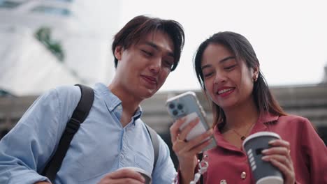 business colleagues discussing on smartphone in city