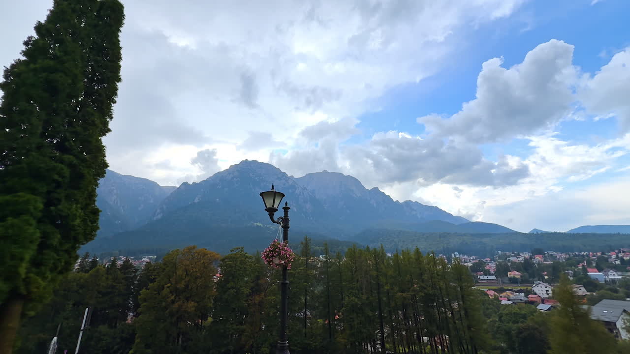 View on Busteni town located in the beautiful mountainous area. Watching the residential area from the territory of the Cantacuzino Castle, Romania during rain