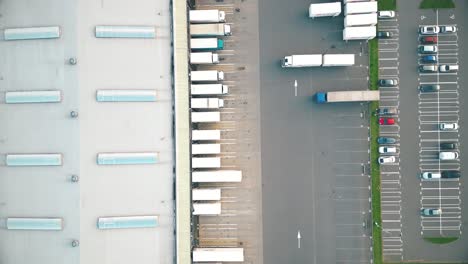 warehouses, huge logistics center near the highway, view of a large number of cargo trailers and containers, international cargo transportation, aerial view