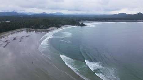 vancouver island coastal scene, waves hitting beach - mountains background