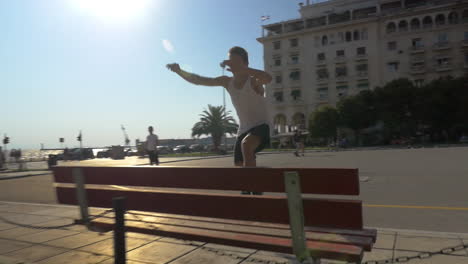 parkour in the city tracer jumping over the bench