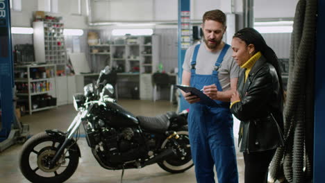 Mechanic-and-rider-talking-at-the-garage