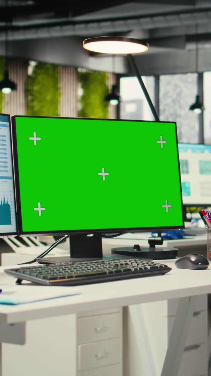 Vertical Video Contemporary office space equipped with green screen on dual monitors