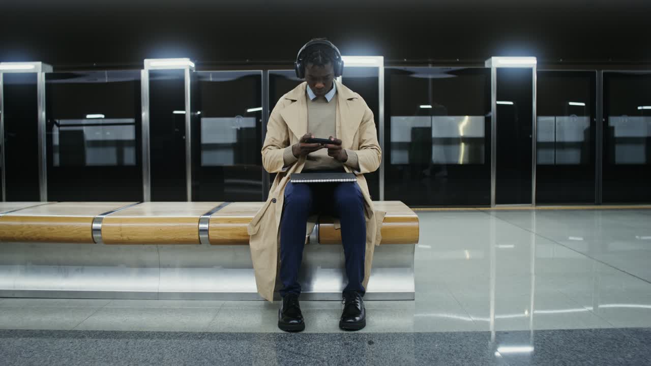 Man Using Smartphone at Subway Station