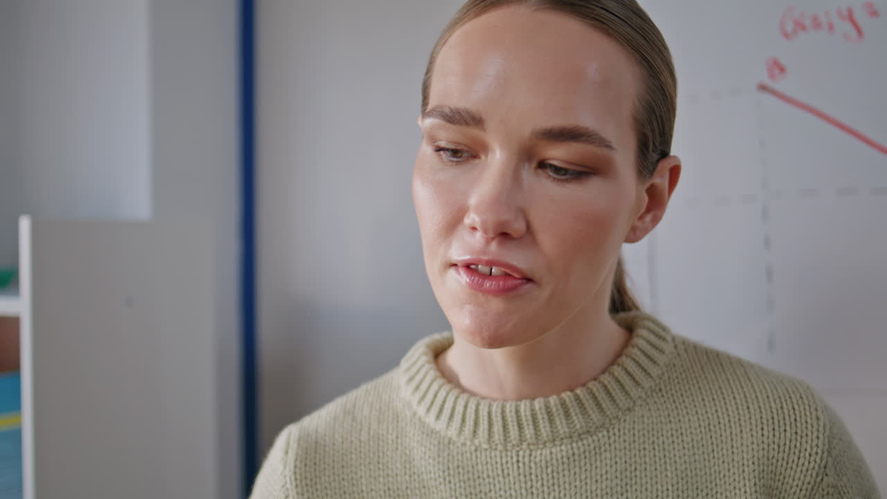 Serious educator writing board at cabinet closeup. Lady talking to auditorium