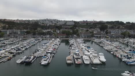 aerial view of many of sailboats and yachts, at the dana point harbor, in california - tracking, drone shot